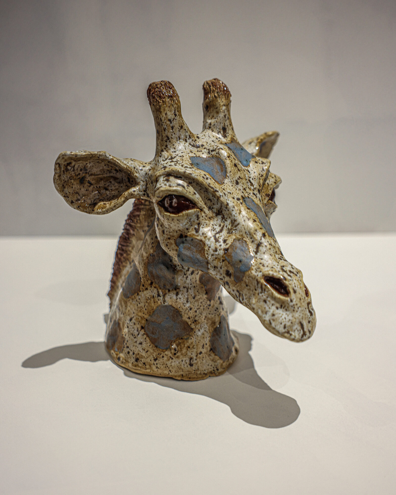 Speckled stoneware giraffe head sculpture