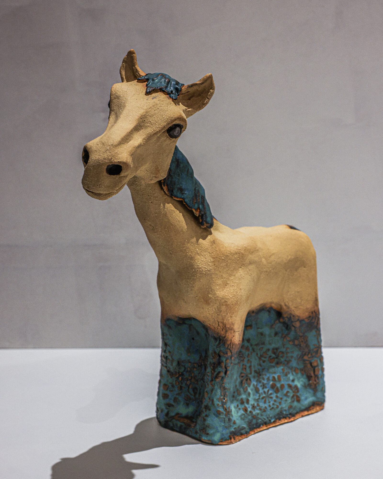 Stoneware horse sculpture with patterned blue glaze