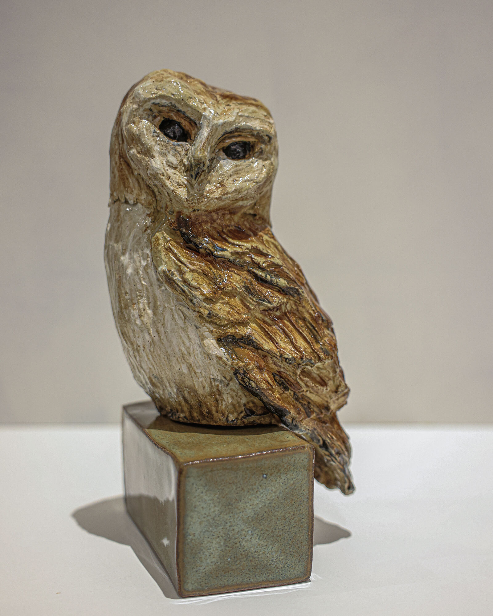 Hand-built ceramic owl on a glazed plinth
